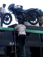 Load motorcycle on the bus roof, the indian way! With his head....
