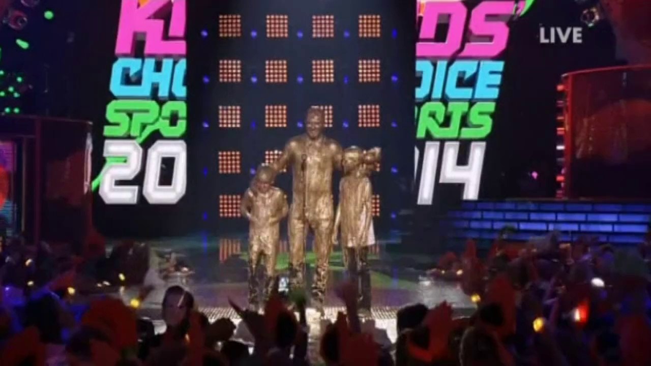 David, Romeo and Cruz Beckham covered in gold gunk at awards