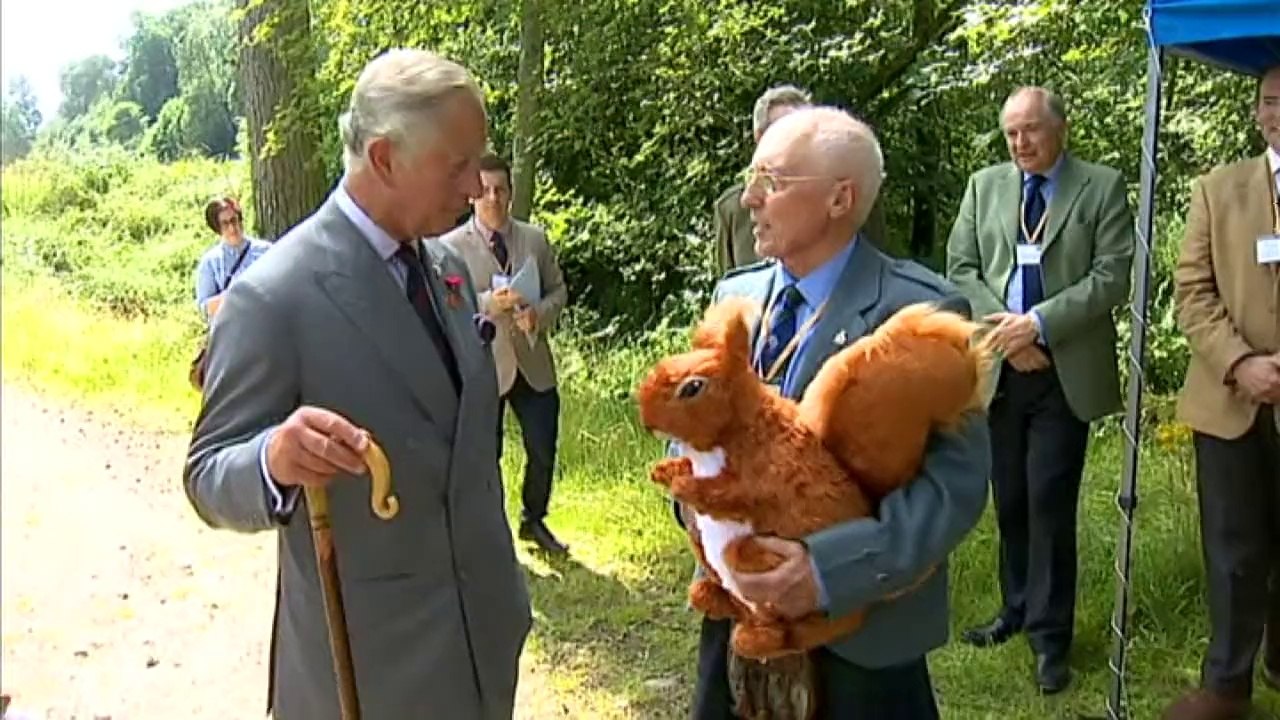 Prince Charles presented with large cuddly squirrel toy