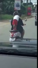 FATHER AND DAUGHTER RIDING THE MOTORCYCLE.