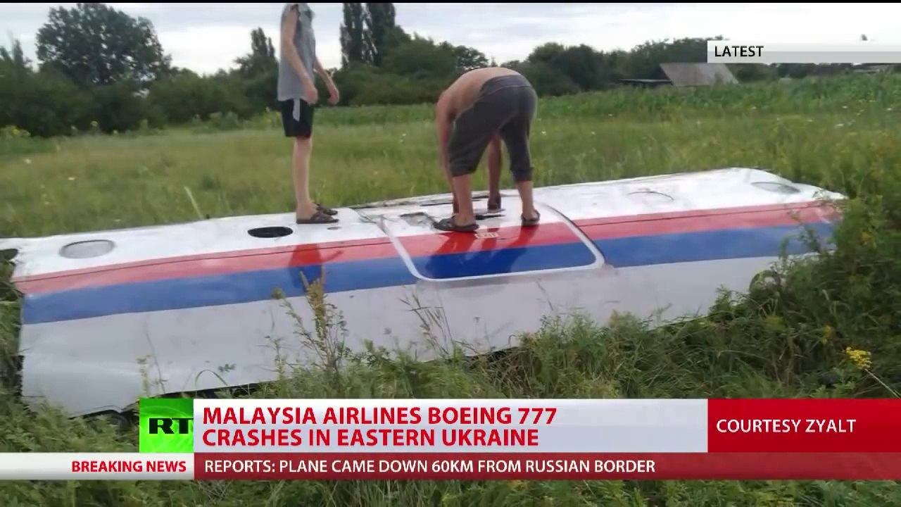 Malaysia MH17 crash site witness bodies debris passports scattered