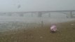 Beach-goers run for cover during freak hail storm in Russia