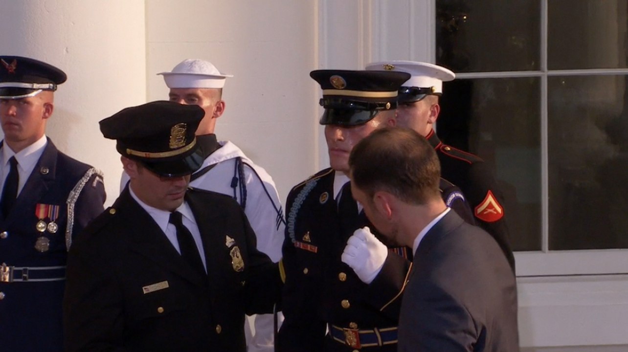 Honor guard appears to fall ill at White House
