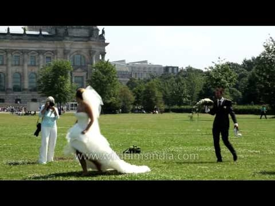 New bride in Berlin poses before the Reichstag, Germany