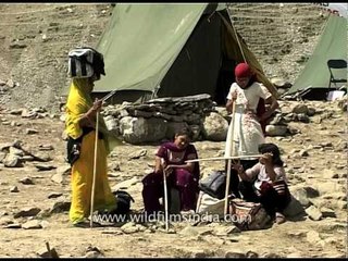 Woman devotee carries a bag on her head en route to Amarnath