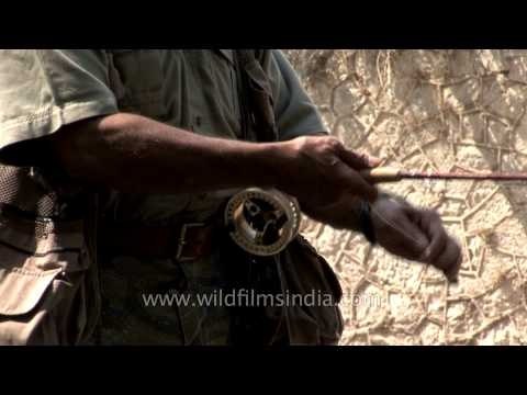 Angler with his rod and reel fishing in Kashmir