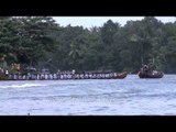 Participants rowing in ryhthm during Champakulam snake boat race - India