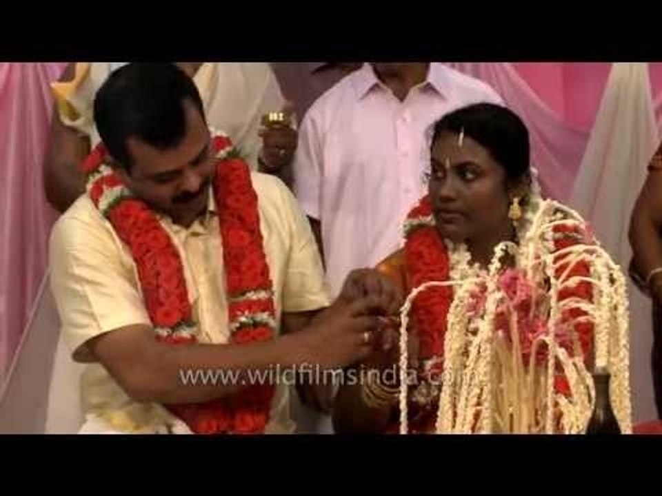 Groom and bride exchange wedding rings: Kerala...