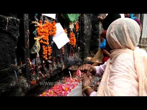 Devotees offer incense sticks, candles and flowers to the Djinns