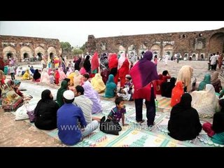 Women offer prayer amongst the ruins of  Feroz Shah Kotla Fort