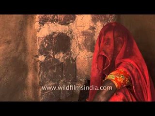 Traditional kitchen in India : Rajasthani woman veils her face with sari