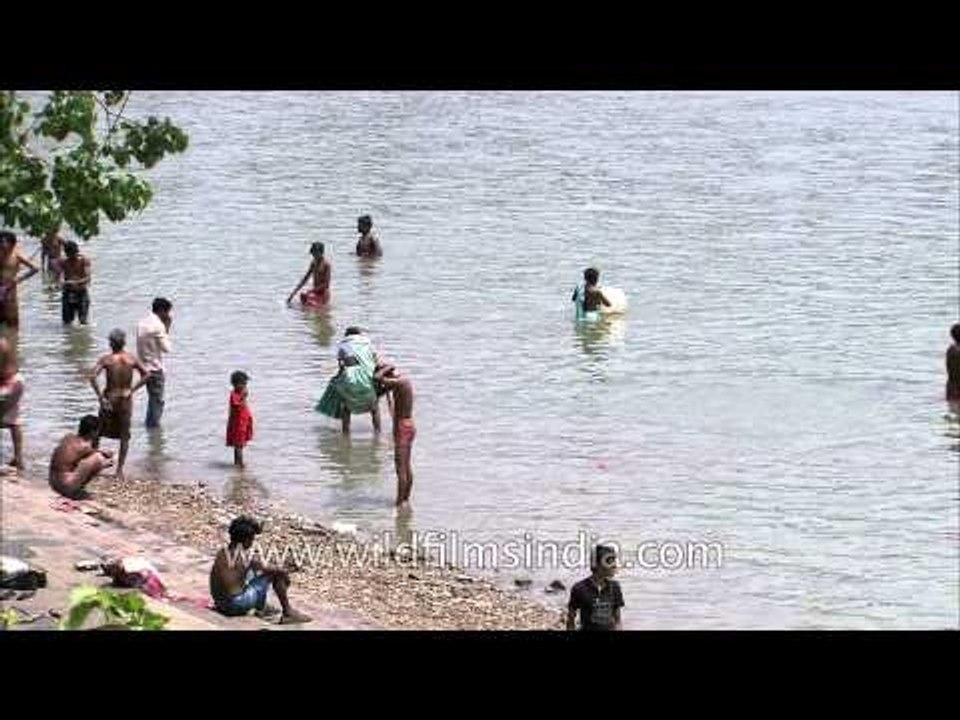 People bathing on the Hooghly river near Howrah Bridge