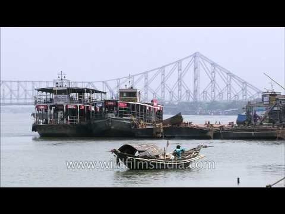 Ferries on river Hooghly against the backdrop of Howrah Bridge