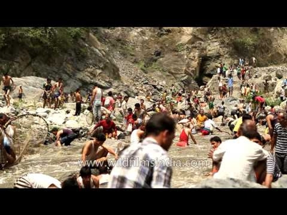 Villagers catch fishes in River Aglar during Maund mela