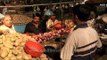 Customers buying onions and potatoes at Kolkata vegetable market