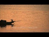 Wooden boat sailing down Hooghly river at sunset - West Bengal