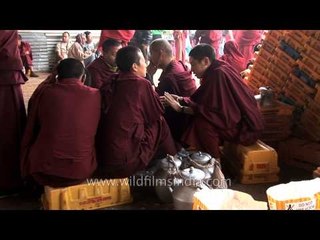 Young monks warm themselves around a bonfire - Kalachakra, Bodhgaya