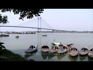 Boats in Hooghly River and seen far behind is Vidyasagar Setu