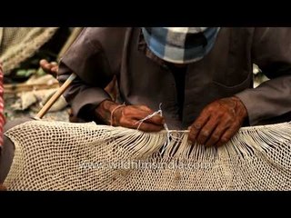 Participant makes fishing net to catch fish at Maund mela