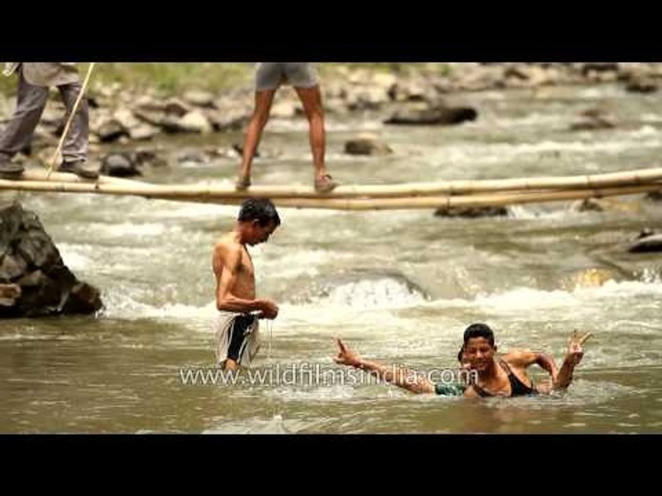 Villagers splashing around in River Aglar during Maund mela
