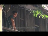 Girl watches a religious procession on streets of Kolkata