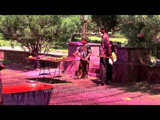 Children pouring colour water over each other