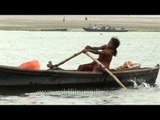 Young girl rowing a boat on the Ganges - Varanasi