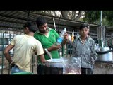 Tea lovers drink tea from outside tea stall in Delhi