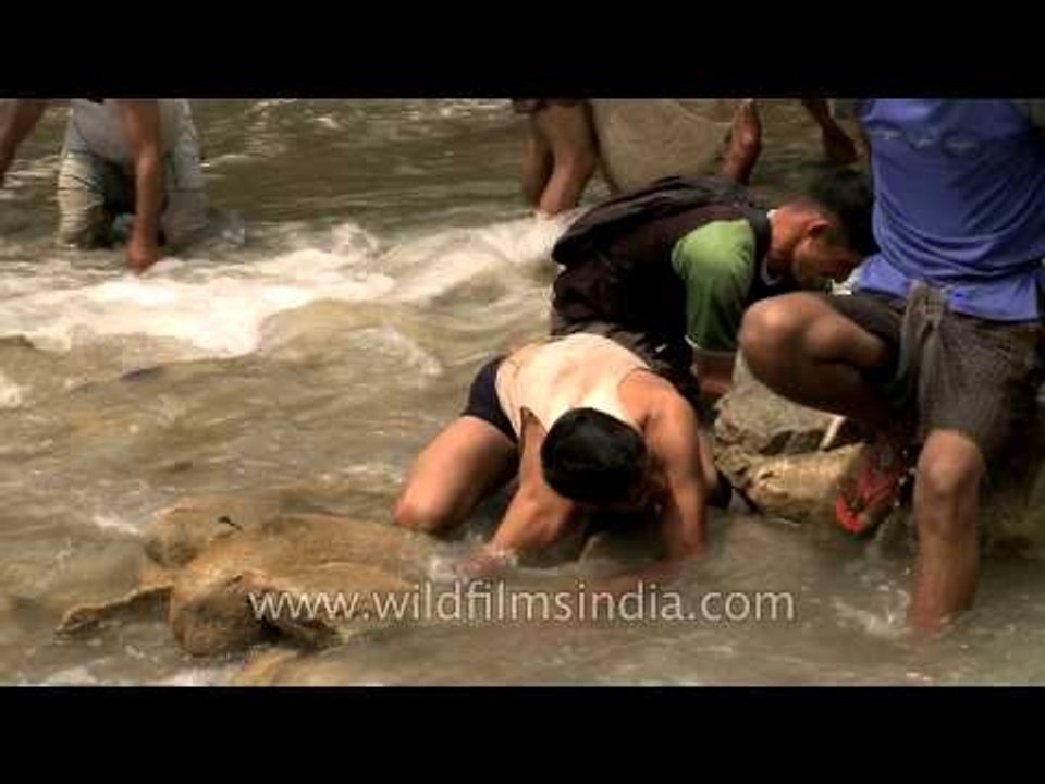 People catching fish during Maund Mela at Aglar River