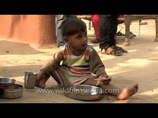 Indian village kid eats a meagre meal of insufficient nutritional value