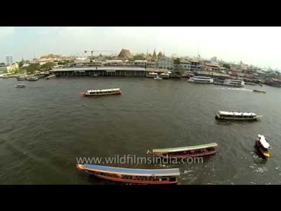 Boat traffic on Chao Phraya river in Bangkok, Thailand