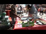 Man baking cookies in typical coal fired oven in Haridwar market