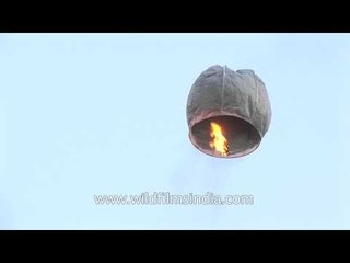 People prepare to release hot air balloon during Dussehra celebration in Delhi
