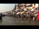 Devotees have a holy dip in river Ganga at Dashashwamedh Ghat, Varanasi