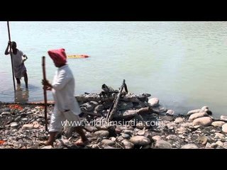 Caretaker stokes the flames of pyre
