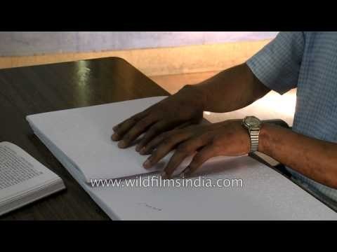 Blind or visually handicapped reading text in braille at Central braille press