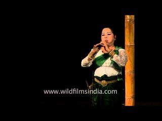 Lady plays flute at an event in Delhi