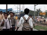 Indian school kids with British school ties   crowded train commuters disembark