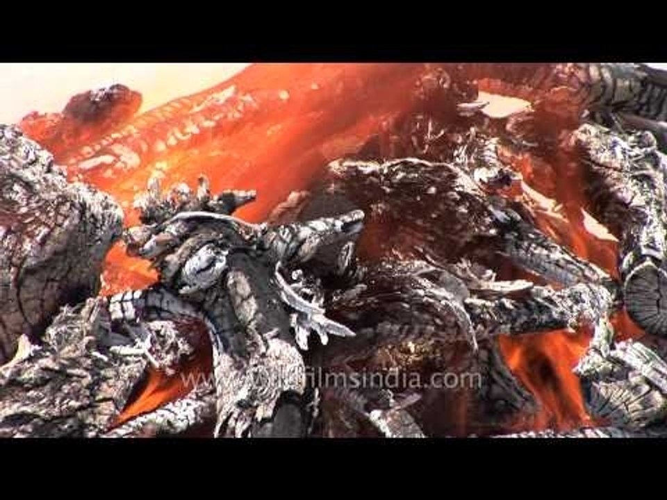 Pyre burns at a cremation ground on the banks of river Ganga