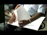 Differently-abled: Visually-challenged man reading text book in braille