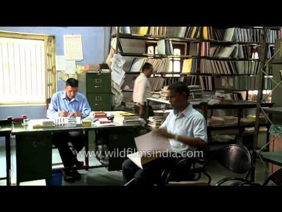 Visually challenged man walking with stick at Central braille press