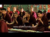 Monks eating veg patties and drinking tea after meditation