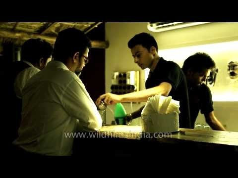 Bartenders serving beer: Dzukou restaurant, Delhi