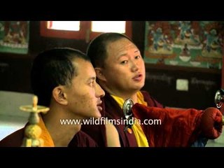 Monks blowing large Monastery trumpets