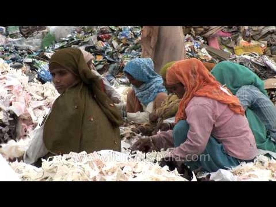 Women workers sorting waste paper at a recycling yard in India