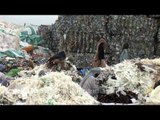 Workers sorting waste papers for recycling