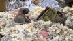 Workers sorting waste paper for recycling at a recycling yard in India