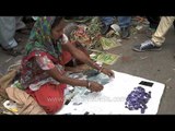 Woman selling stones that break tiles and glasses - Daryaganj