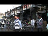 An old knife-sharpener working on the streets of Lohaghat