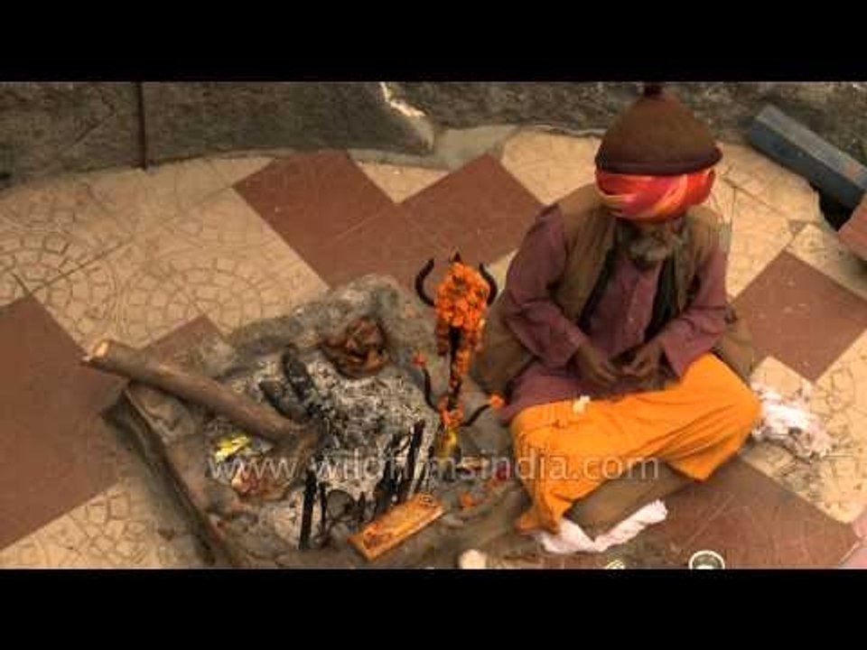 Baba sitting in front of Shri Garud Shila - Badrinath